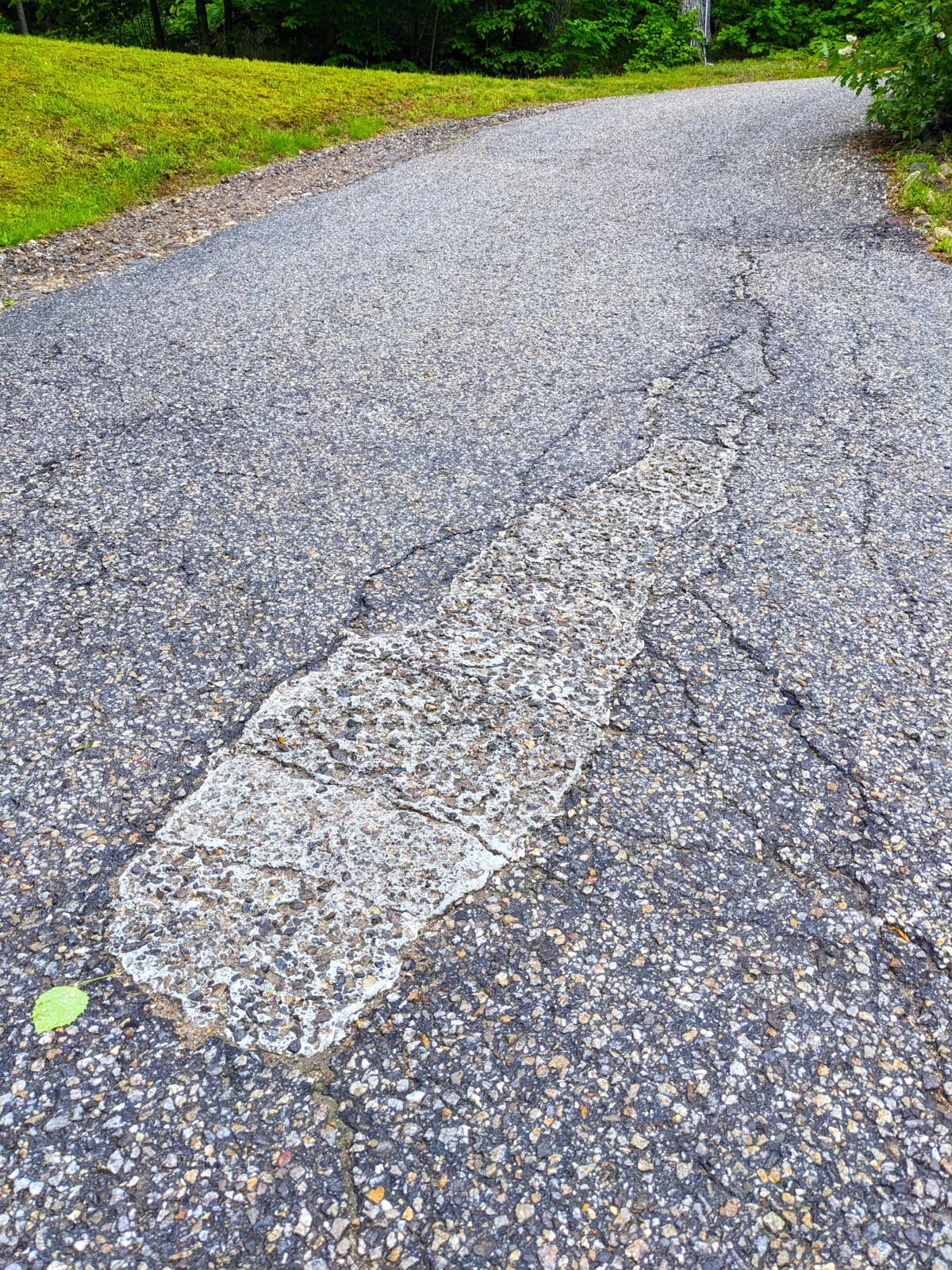 The homeowner repaired a sinking hole in this blacktop drive using epoxy and stones. It’s time to cut it out and install real hot mix asphalt. (Tim Carter/Tribune Content Agency)