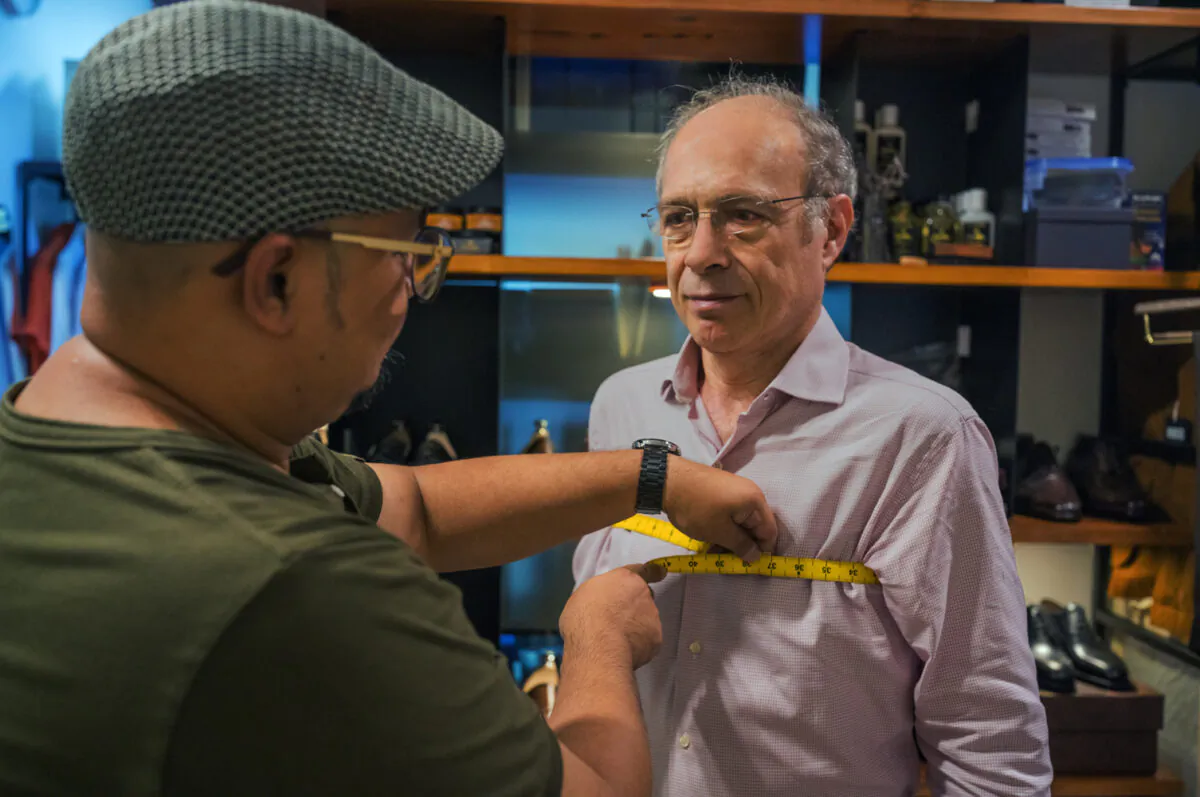 Akira, senior tailoring specialist, takes the author's measurements at Yeossal & Co. in Singapore. (Alan Behr/TNS)