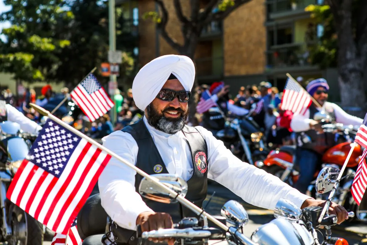 A Sikh man rides a motorcycle with the "Sikh Riders of America" group during the 4th of July Parade in Alameda, Calif., on July 4, 2016. (Gabrielle Lurie/AFP via Getty Images)