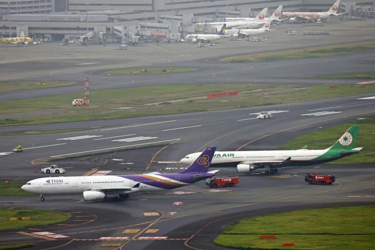 An aerial view shows Thai Airways and Eva Air aeroplanes on a taxiway after making contact at Haneda Airport, in Tokyo, Japan, on June 10, 2023. (Kyodo via Reuters)