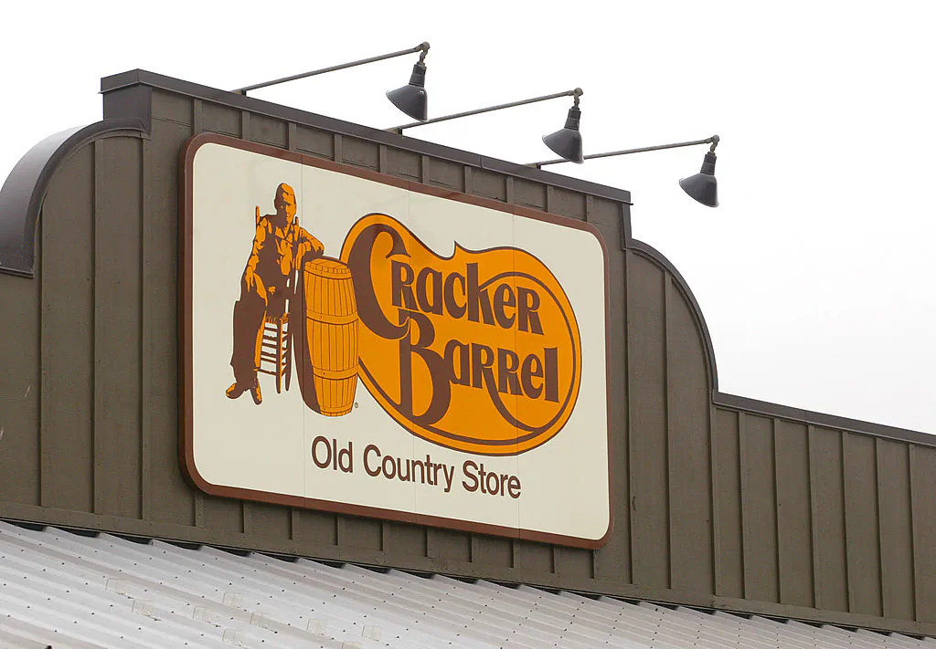 A Cracker Barrel Old Country Store sign is visible atop one of its restaurant stores April 12, 2002 in Naperville, IL. (Photo by Tim Boyle/Getty Images)