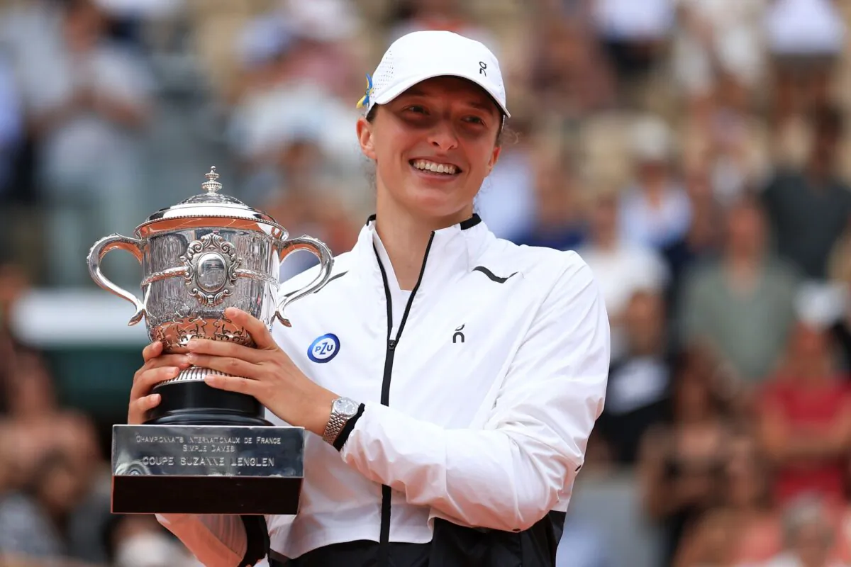 Poland's Iga Swiatek holds the trophy as she celebrates winning the women's final match of the French Open tennis tournament against Karolina Muchova of the Czech Republic at the Roland Garros stadium in Paris on June 10, 2023. (Aurelien Morissard/AP Photo)