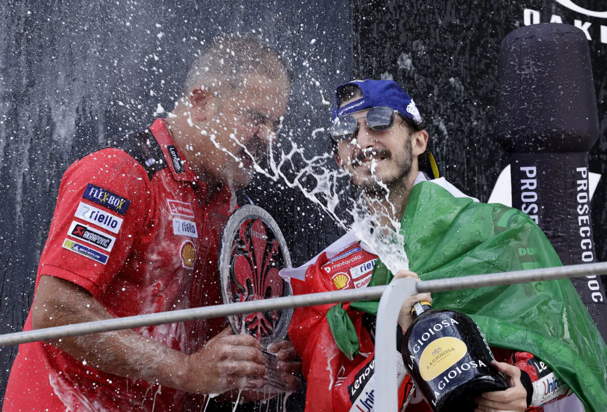 Ducati Lenovo's Francesco Bagnaia sprays sparkling wine as he celebrates on the podium after winning the race at the Italian Grand Prix in Scarperia e San Piero, Italy, on May 29, 2022. (Ciro De Luca/Reuters)