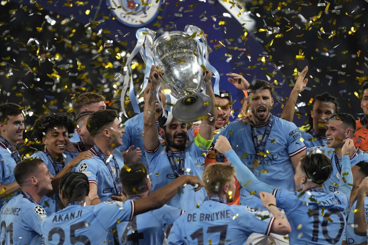 Manchester City's Ilkay Gundogan holds up the trophy after winning the Champions League final soccer match between Manchester City and Inter Milan at the Ataturk Olympic Stadium in Istanbul, Turkey, on June 10, 2023. (Antonio Calanni/AP Photo)