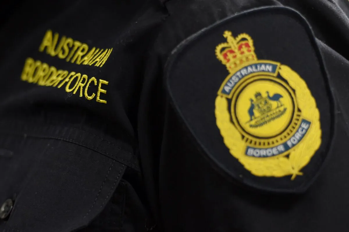 Victorian police, Australian Federal Police, and Australian Border Force officers stand at the Australian Federal Police offices in Melbourne, Australia, on July, 4, 2016.
