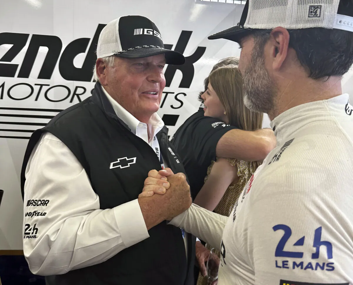 Hendrick Motorsports team owner Rick Hendrick (L) congratulates NASCAR champion Jimmie Johnson after the Garage 56 car finished the 24 Hours of Le Mans auto race in Le Mans, France, on June 11, 2023. (Jenna Fryer/AP Photo)
