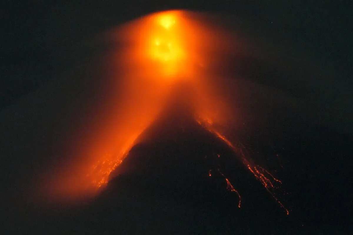 Mayon volcano belches red-hot emissions down its slope as seen from Legaspi, Albay province, northeastern Philippines, on June 11, 2023. (Aaron Favila/AP Photo)