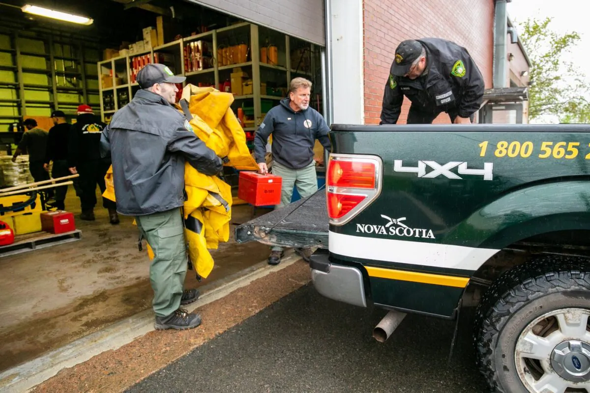 Firefighters from the Northeastern United States help load a truck with supplies in Shubenacadie, N.S., on June 3, 2023, to assist with fighting wildfires in Nova Scotia. (The Canadian Press/Kelly Clark)