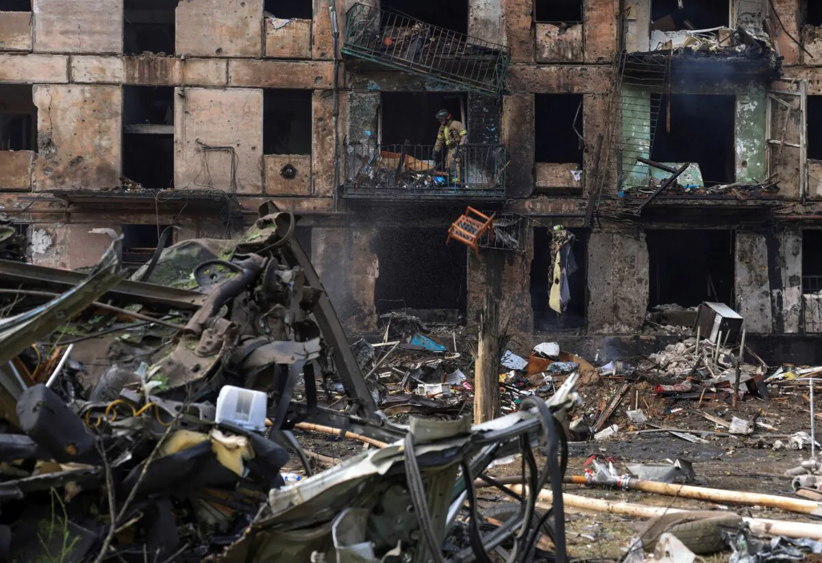 A rescuer works at the site of a building heavily damaged by a Russian missile strike in Kryvyi Rih, Dnipropetrovsk region, Ukraine, on June 13, 2023. (Andrii Dubchak/Reuters)
