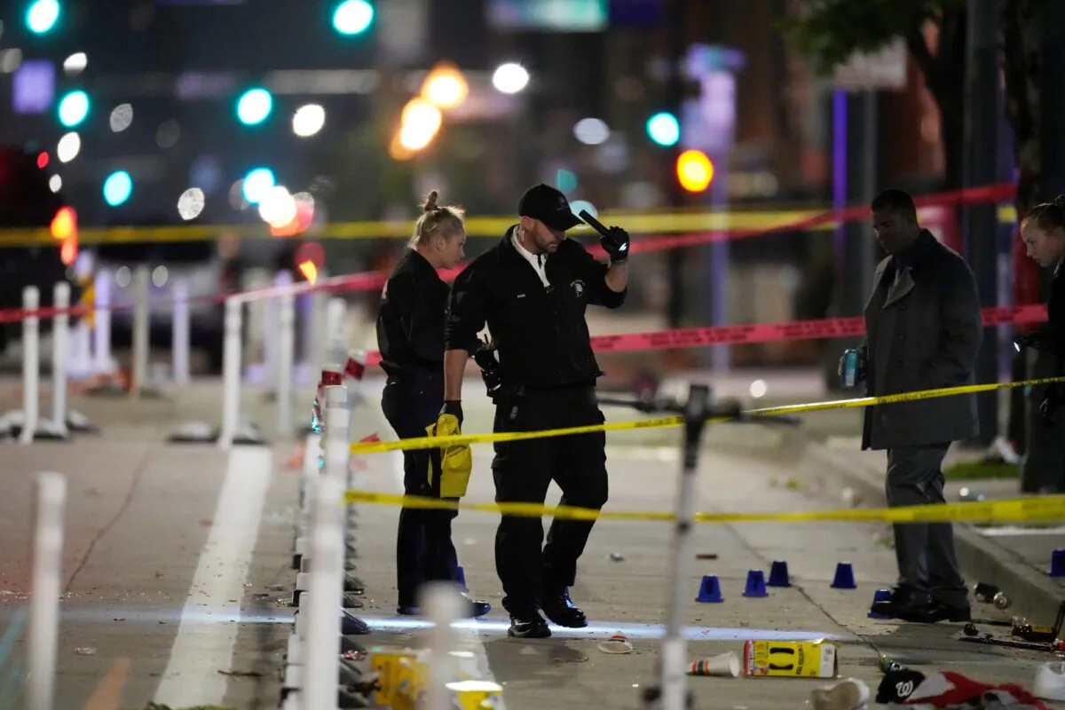 Denver Police Department investigators work the scene of a shooting along Market Street during a celebration after the Denver Nuggets won the team's first NBA Championship in Denver on June 13, 2023. (David Zalubowski/AP Photo)