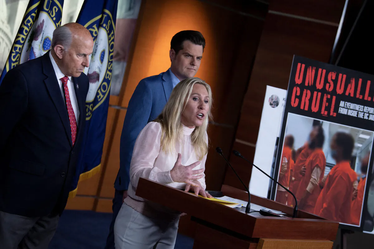 U.S. Rep. Marjorie Taylor Greene (R-Ga.), with colleagues Matt Gaetz (R-Fla.) and Louie Gohmert (R-Texas) (left), speaks at a press conference addressing the treatment of the Jan. 6 detainees at the D.C. jail in Washington on Dec. 7, 2021. (Brendan Smialowski/AFP via Getty Images)