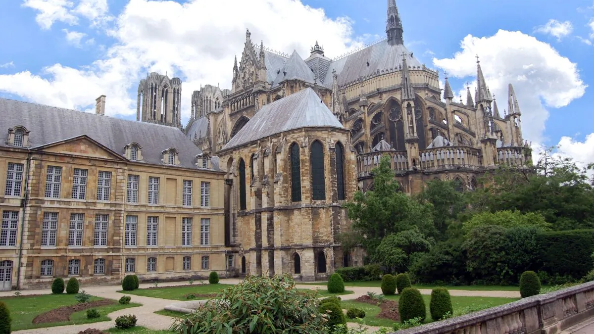 A glorious example of Gothic architecture, Reims Cathedral's construction began in 1211. Around the back of the church, flying buttresses are hard at work, supporting the massive structure. (Rick Steves, Rick Steves' Europe)