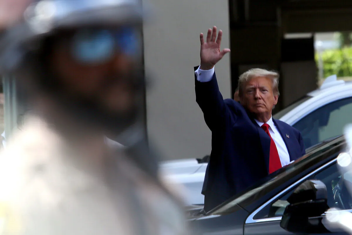Former President Donald Trump waves as he makes a visit to the Cuban restaurant Versailles after he appeared for his arraignment in Miami on June 13, 2023. (Alon Skuy/Getty Images)