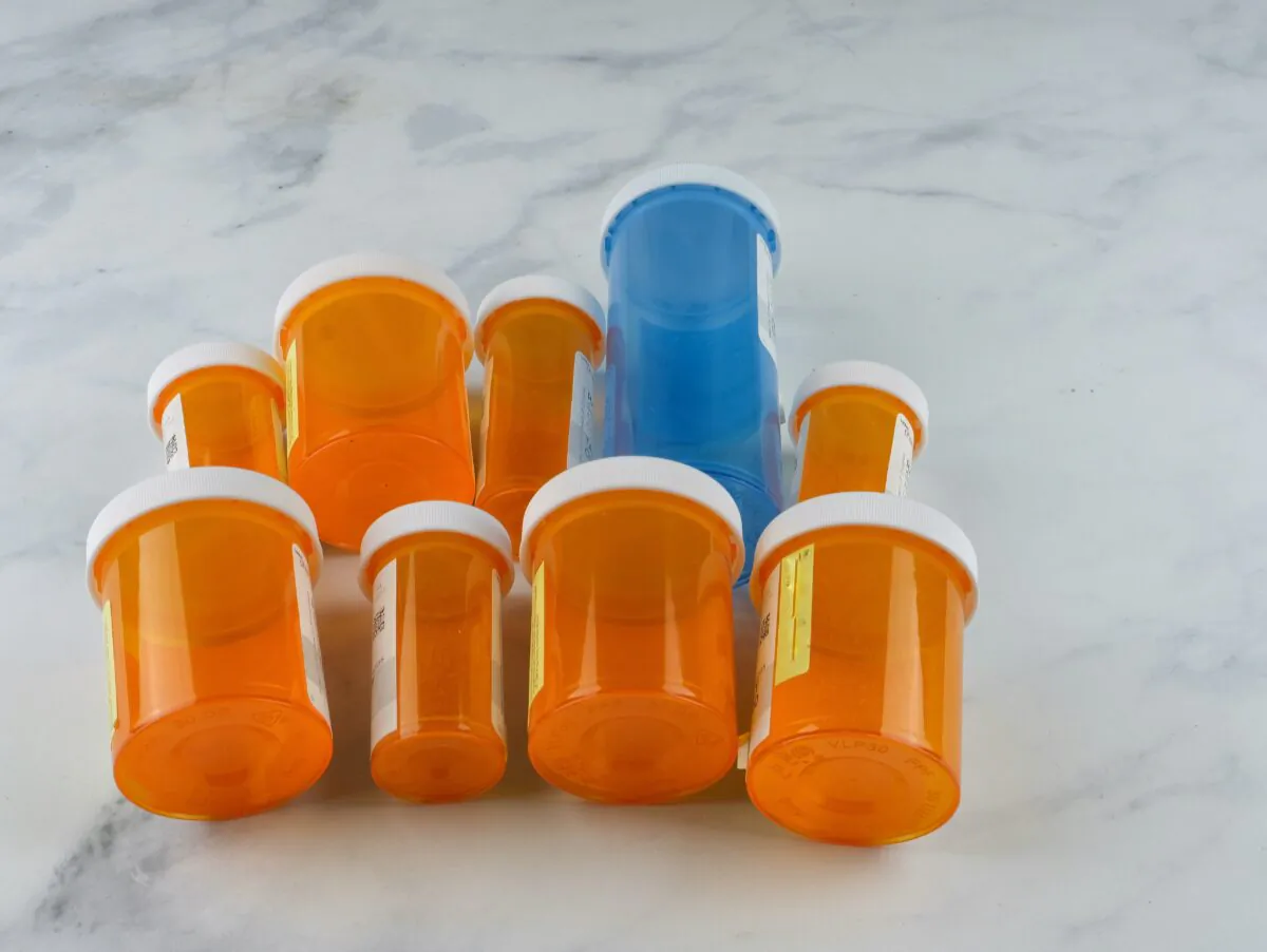 Empty prescription bottles can be repurposed to store needles, buttons, or other small items. (Nancy Salmon/Shutterstock)