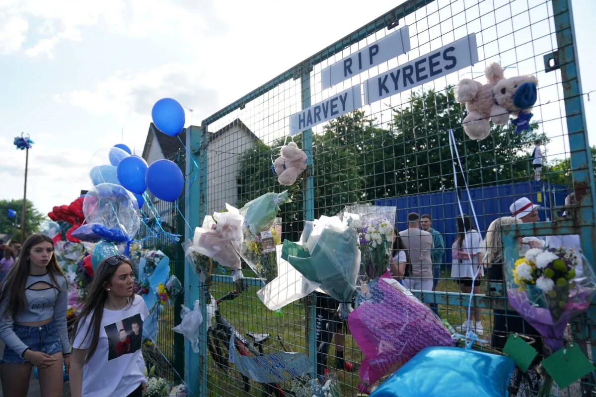 People attend a vigil for the two victims of a road traffic collision on Snowden Road in Ely, Cardiff, on May 26, 2023. (PA)