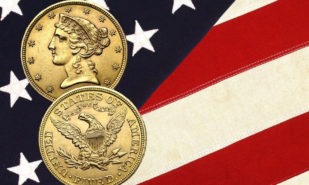 Liberty gold coin atop stars and stripes. (Nancy A Thiele/Shutterstock)