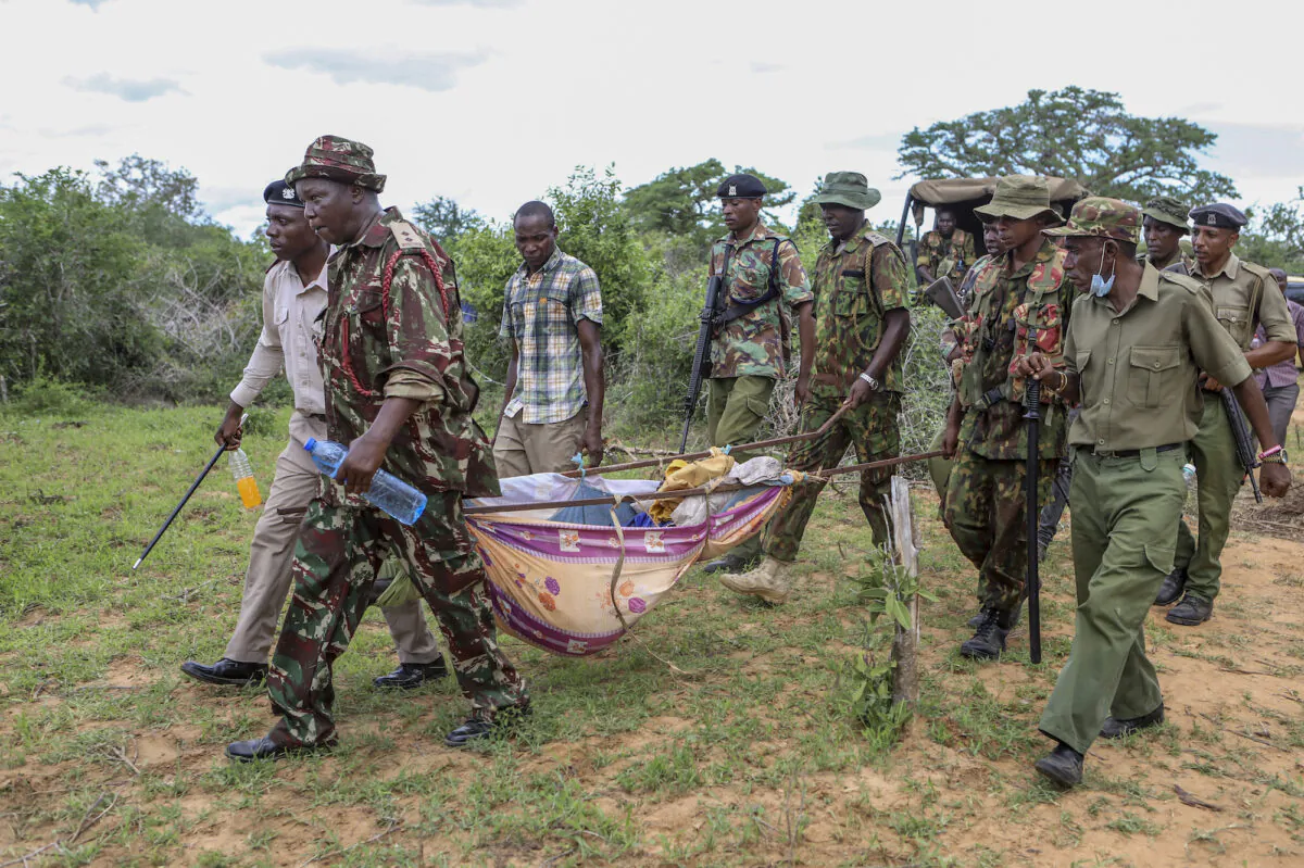 Police and local residents load the bodies of victims of a religious cult into the back of a truck in the village of Shakahola, near Malindi in southern Kenya on April 23, 2023. (AP Photo, File)