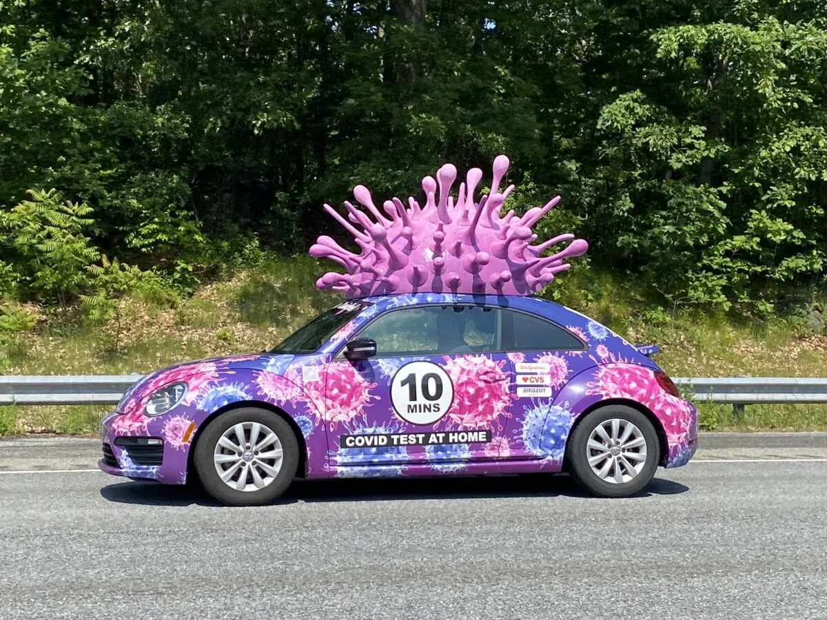 A car advertising home COVID tests makes it way down a Massachusetts highway on June 11, 2023 (Alice Giordano)