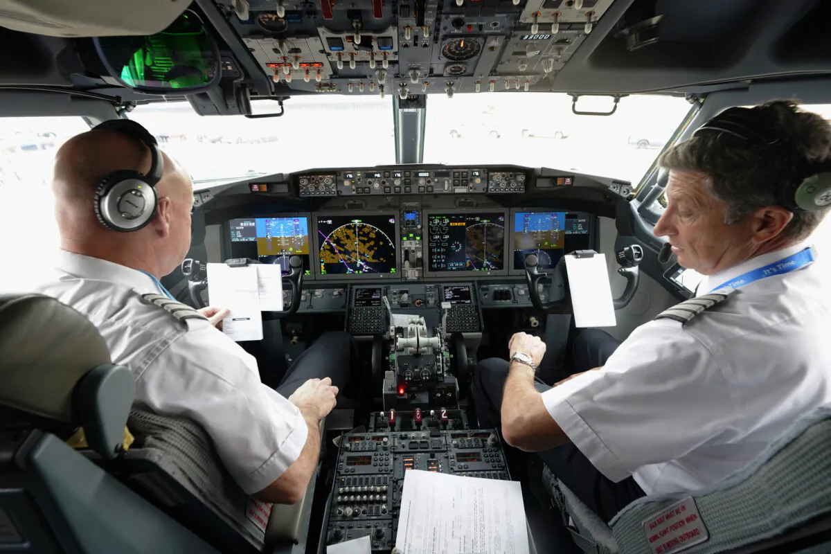 American Airlines pilot captain Pete Gamble (L) and first officer John Konstanzer conduct a pre-flight check in the cockpit of a Boeing 737 Max jet in Grapevine, Texas, on Dec. 2, 2020. (LM Otero/AP Photo)