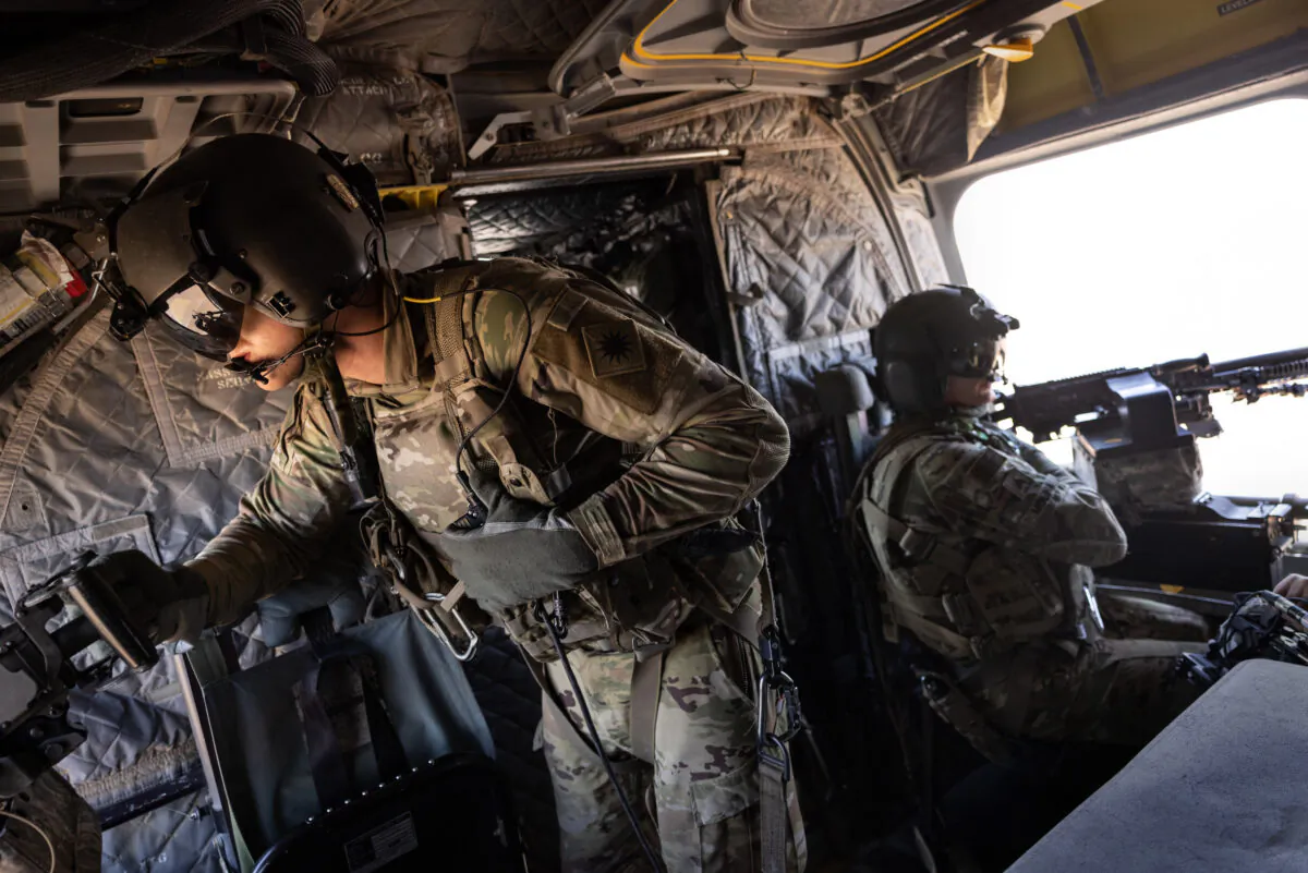 NORTHEASTERN SYRIA - MAY 26: U.S. Army CH-47 Chinook helicopter gunners scan the desert while transporting troops on May 26, 2021 over northeastern Syria. U.S. forces, part of Task Force WARCLUB operate from remote combat outposts in northeastern Syria, coordinating with the Syrian Democratic Forces (SDF) in combatting residual ISIS extremists and deterring pro-Iranian militia. (Photo by John Moore/Getty Images)