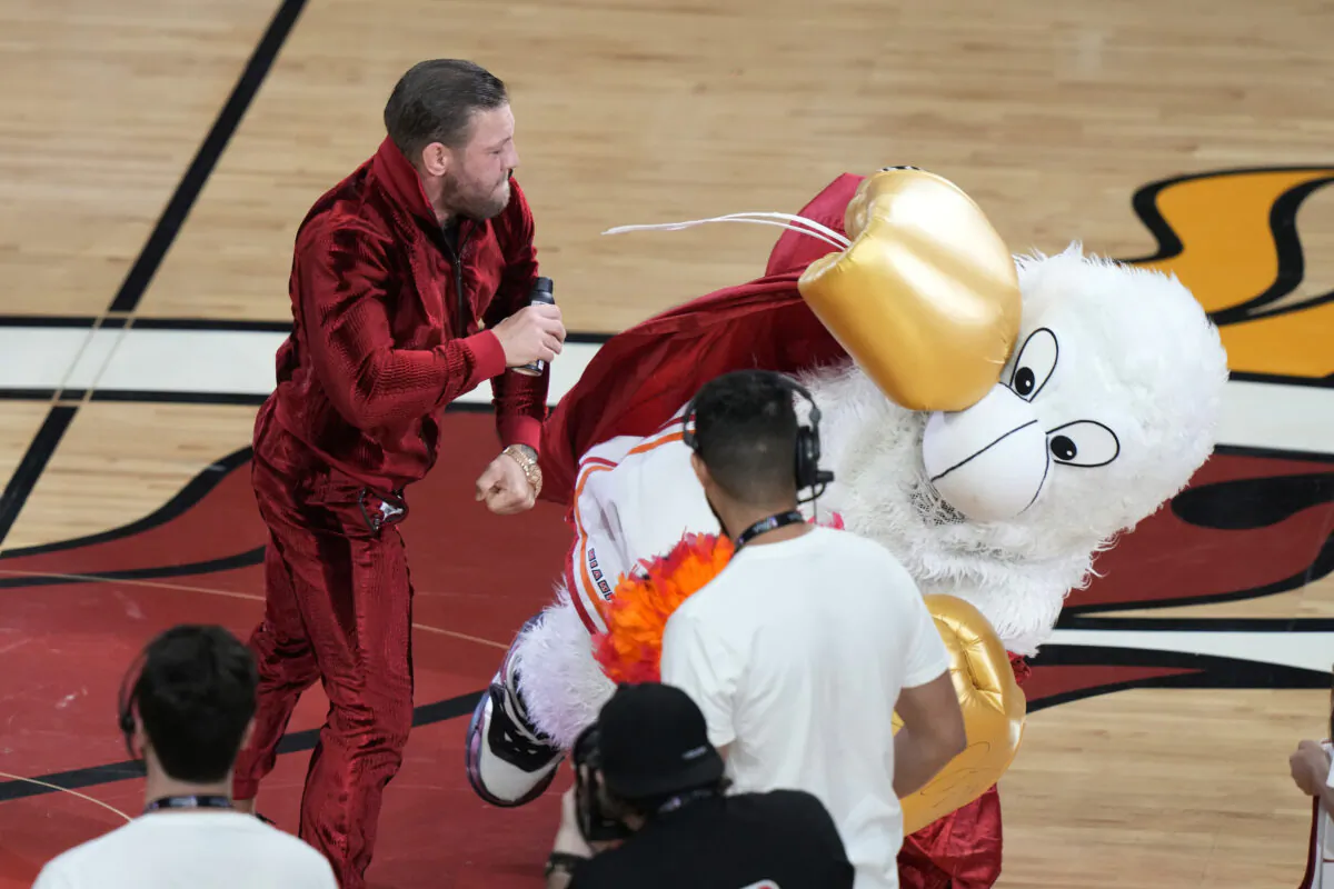 Former MMA fighter Conor McGregor punches Burnie, the Miami Heat mascot, during a break in the NBA Finals in Miami, Fla., on June 9, 2023. (Lynne Sladky/AP Photo)