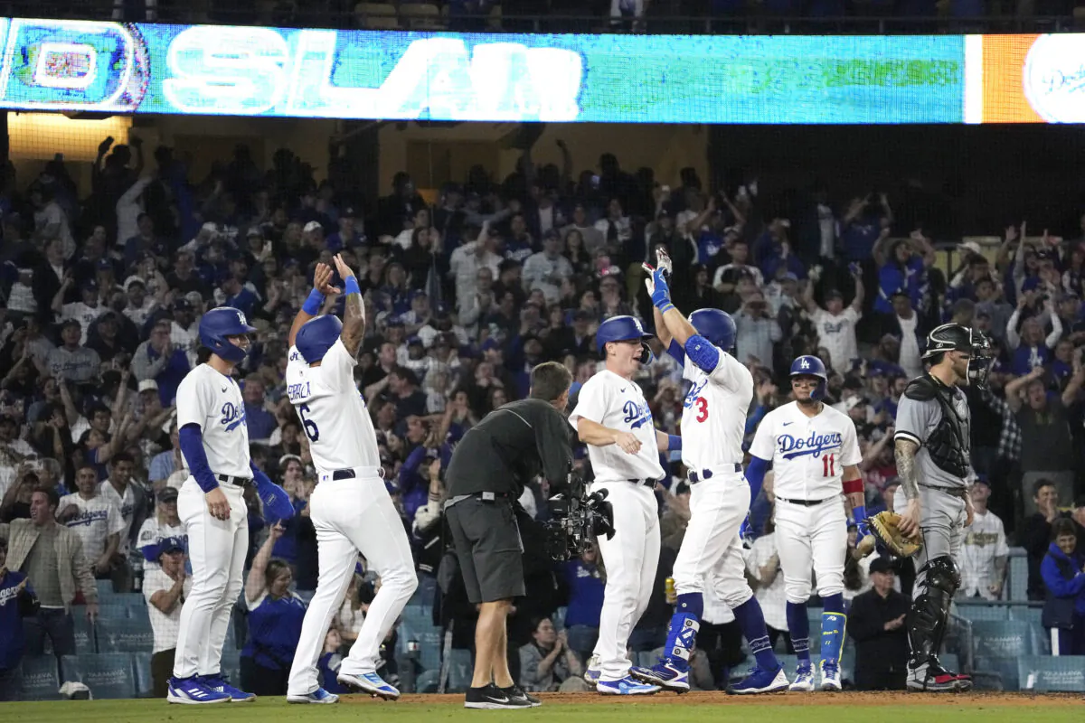 Los Angeles Dodgers' Chris Taylor (3) is congratulated by David Peralta (6), James Outman (33) and Will Smith (16) after hitting a grand slam as Chicago White Sox catcher Yasmani Grandal (24) stands at the plate and Miguel Rojas watches during the sixth inning of a baseball game in Los Angeles on June 15, 2023,. (Mark J. Terrill/AP Photo)