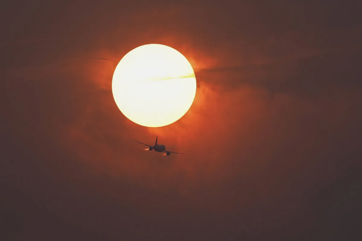 A commercial airline flies past the sun covered in haze made from smoke of Canadian wildfires in Washington on June 7, 2023. (Anna Moneymaker/Getty Images)
