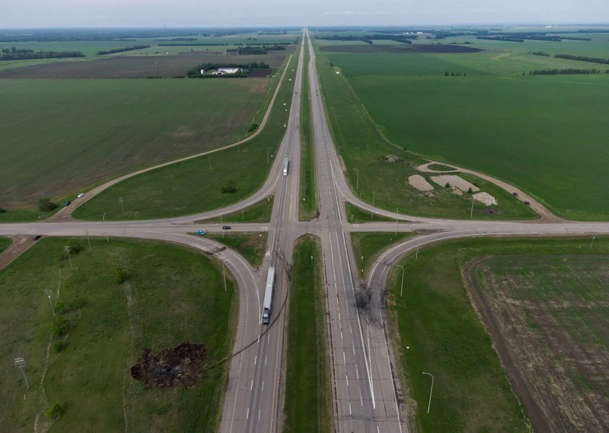 A scorched patch of ground where a bus carrying seniors ended up after colliding with a transport truck and burning on Thursday is seen on the edge of the Trans-Canada Highway where it intersects with Highway 5, west of Winnipeg near Carberry, June 16, 2023. (The Canadian Press/Darryl Dyck)