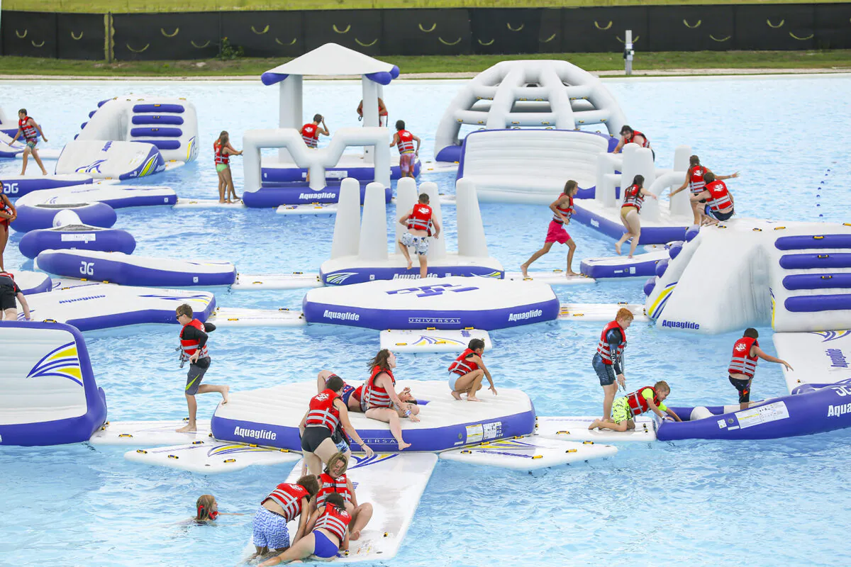 Children play on an Aquaglide (aquatic playground) while exploring Mirada Lagoon, a 15-acre resort-style lagoon in the Mirada master-planned community, on Monday in San Antonio in Pasco County. (Douglas R. Clifford/Tampa Bay Times/TNS)