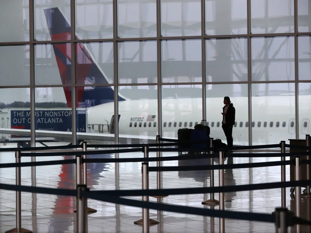 A Delta plane sits at the International Terminal at Hartsfield Jackson International Airport on March 16, 2020, in Atlanta. (Curtis Compton/Atlanta Journal-Constitution/TNS)