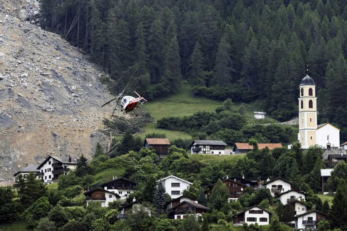A helicopter flies over the rockfall "Brienzer Rutsch" above the village Brienz-Brinzauls in Switzerland, on June 16, 2023. (Michael Buholzer/Keystone via AP)