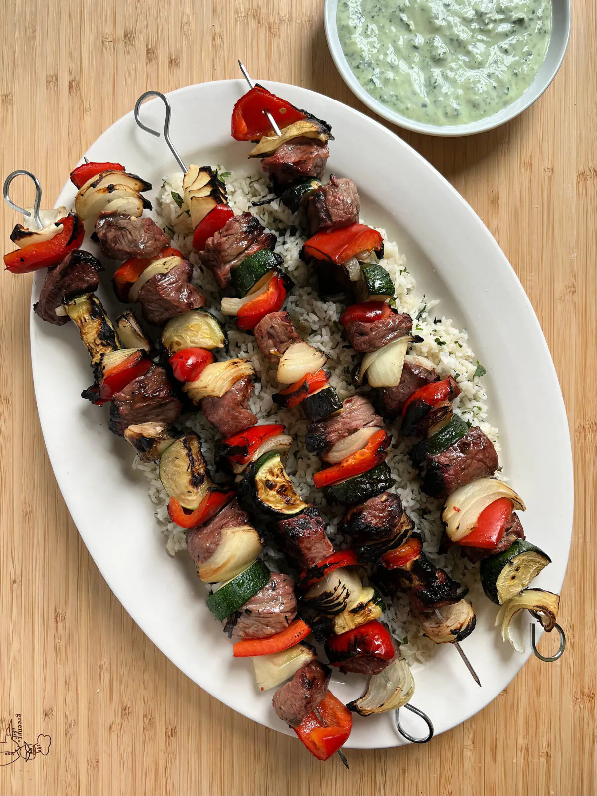 Grilled steak kebabs with spicy cilantro sauce is an easy summer dinner. (Gretchen McKay/Pittsburgh Post-Gazette/TNS)