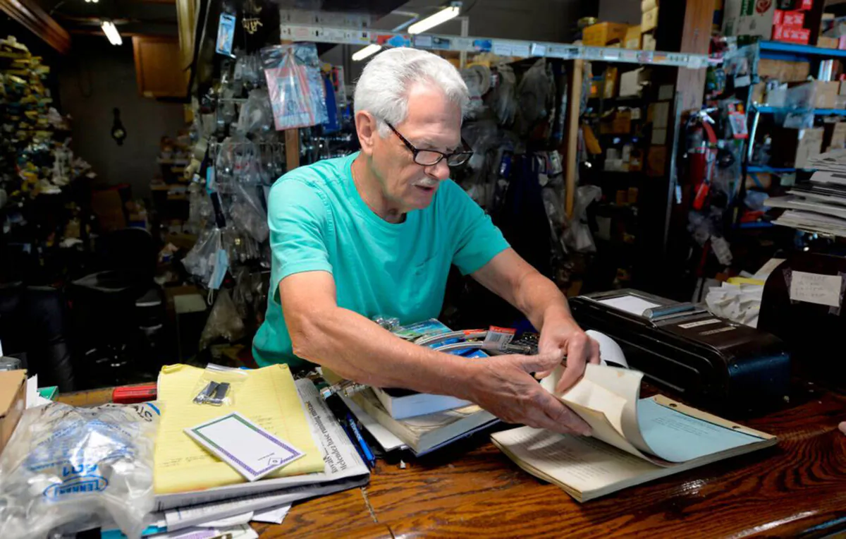 Bill Graham checks some notes while helping a customer. His plumbing supply business moved from midtown Kansas City to Raytown, Missouri in 1999. (Monty Davis/The Kansas City Star/TNS)
