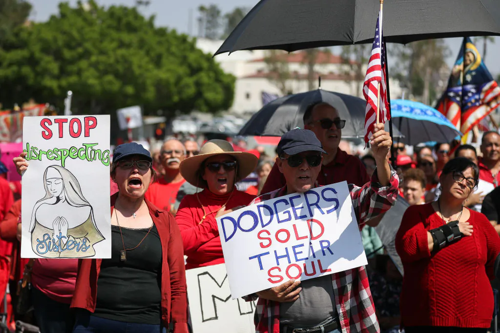 Protesters hold signs at a Catholics for Catholics event in response to the Dodgers' Pride Night event including the Sisters of Perpetual Indulgence prior to the game between the San Francisco Giants and the Los Angeles Dodgers at Dodger Stadium in Los Angeles, Calif., on June 16, 2023. (Meg Oliphant/Getty Images)