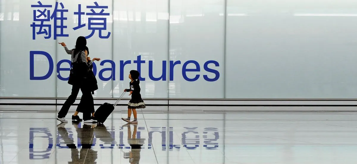 Passengers walk past the departure area at the international airport in Hong Kong on November 17, 2008. (MIKE CLARKE/AFP/Getty Images)