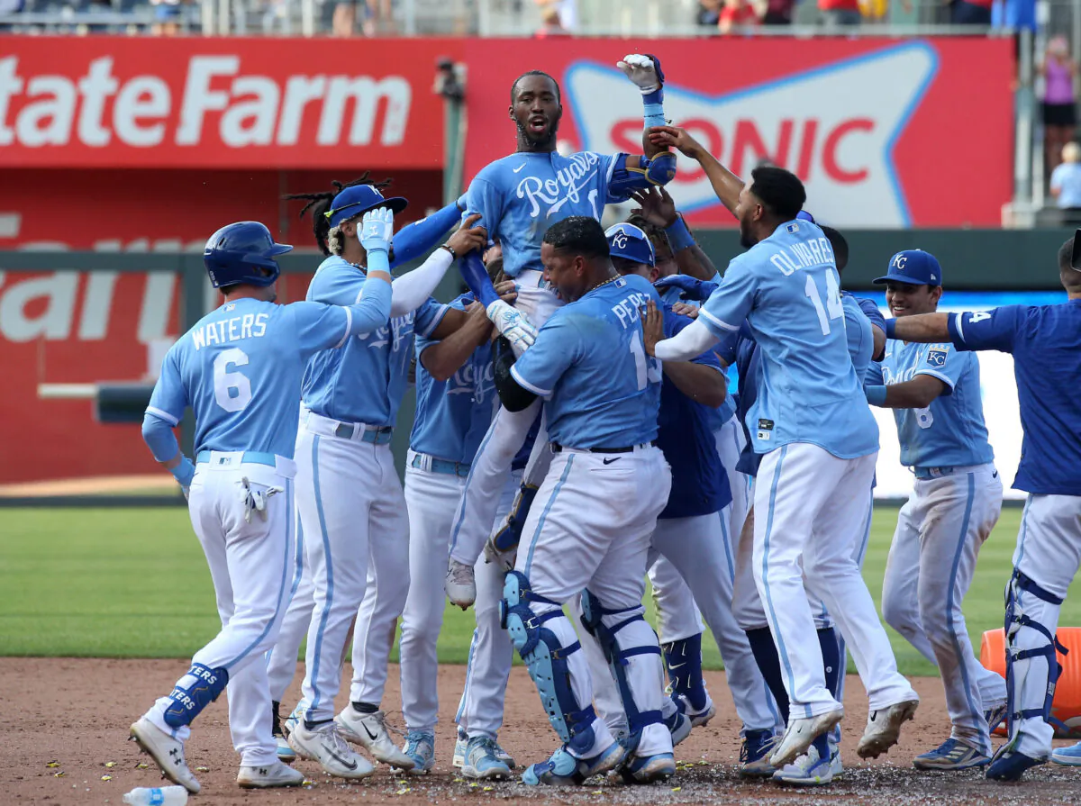Kansas City Royals left fielder Samad Taylor (0) is lifted in the air by teammate Salvador Perez (13) after Taylor hit the game-winning single in his major league debut against the Los Angeles Angels at Kauffman Stadium in Kansas City on June 17, 2023. (Scott Sewell/USA TODAY Sports via Field Level Media)