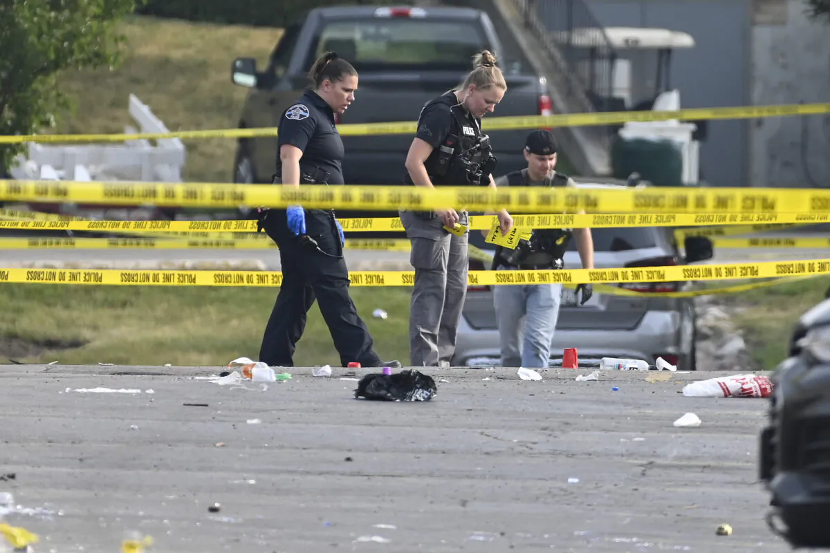 Investigators look over the scene of an overnight shooting at a strip mall in Willowbrook, Ill., on June 18, 2023. (Matt Marton/AP Photo)
