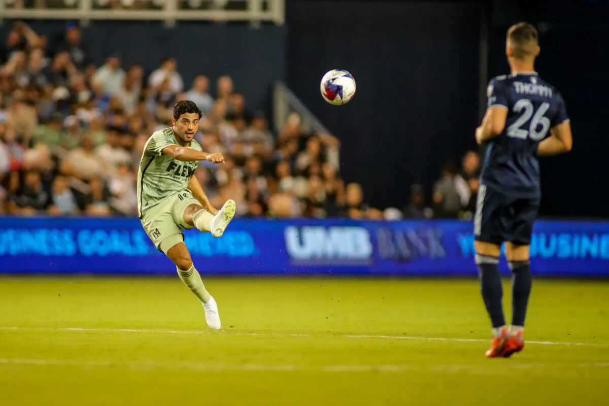 Los Angeles FC forward Carlos Vela (10) takes a shot at goal around Sporting Kansas City's Erik Thommy (26) at Children's Mercy Park in Kansas City on June 17, 2023. (Courtesy of LAFC via The Epoch Times)