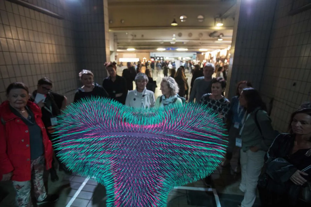 People look at an object during the Ars Electronica in Linz, Upper Austria on Sept. 6, 2019. (Alex Halada/AFP via Getty Images)