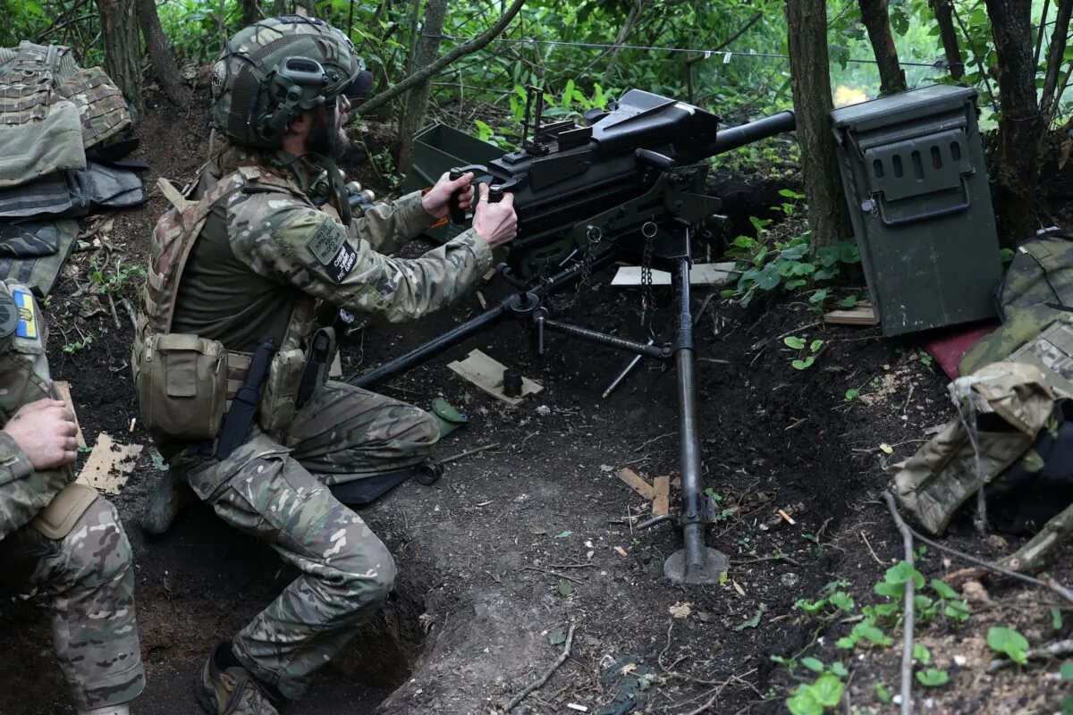 A Ukrainian soldier of the 28th Separate Mechanized Brigade fires a 40mm grenade launcher at the front line near the town of Bakhmut, Donetsk region, amid the Russian invasion of Ukraine, on June 17, 2023. (Anatolii Stepanov/AFP via Getty Images)