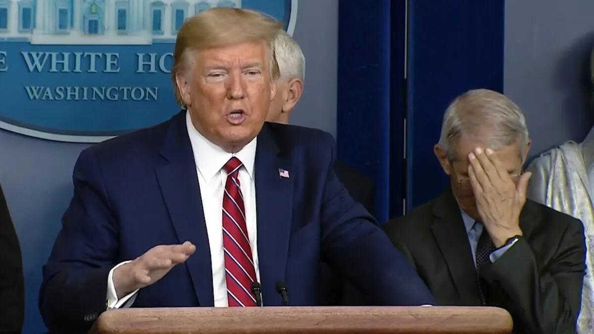 Dr. Anthony Fauci covers his face while President Donald Trump talks during a coronavirus briefing. (White House/Screenshot)