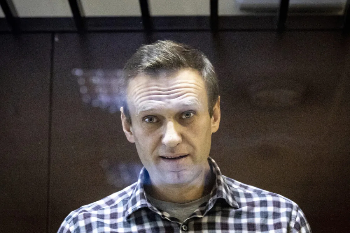 Russian opposition leader Alexei Navalny looks at photographers from inside a glass cage in the Babuskinsky District Court in Moscow on Feb. 20, 2021. (Alexander Zemlianichenko/AP Photo)