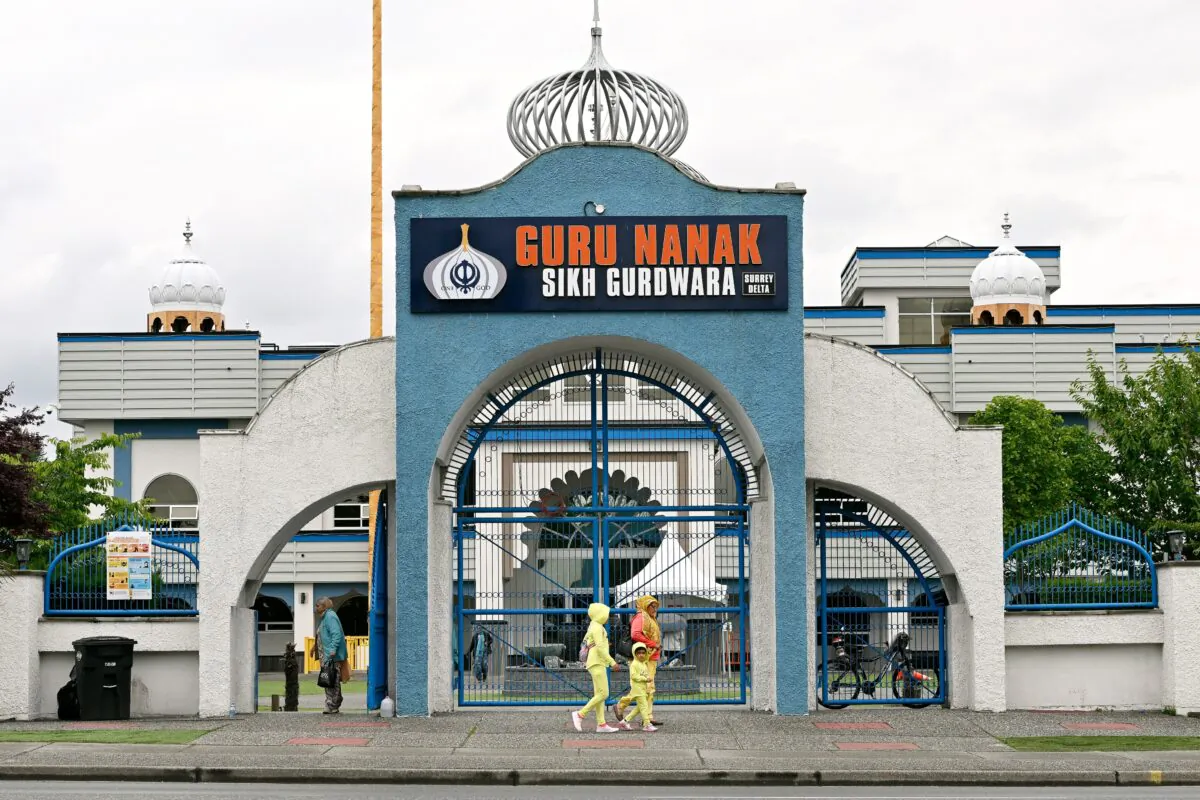 Community members exit the Guru Nanak Sikh Gurdwara Sahib temple in Surrey, B.C., on June 19, 2023. (Jennifer Gauthier/The Canadian Press)
