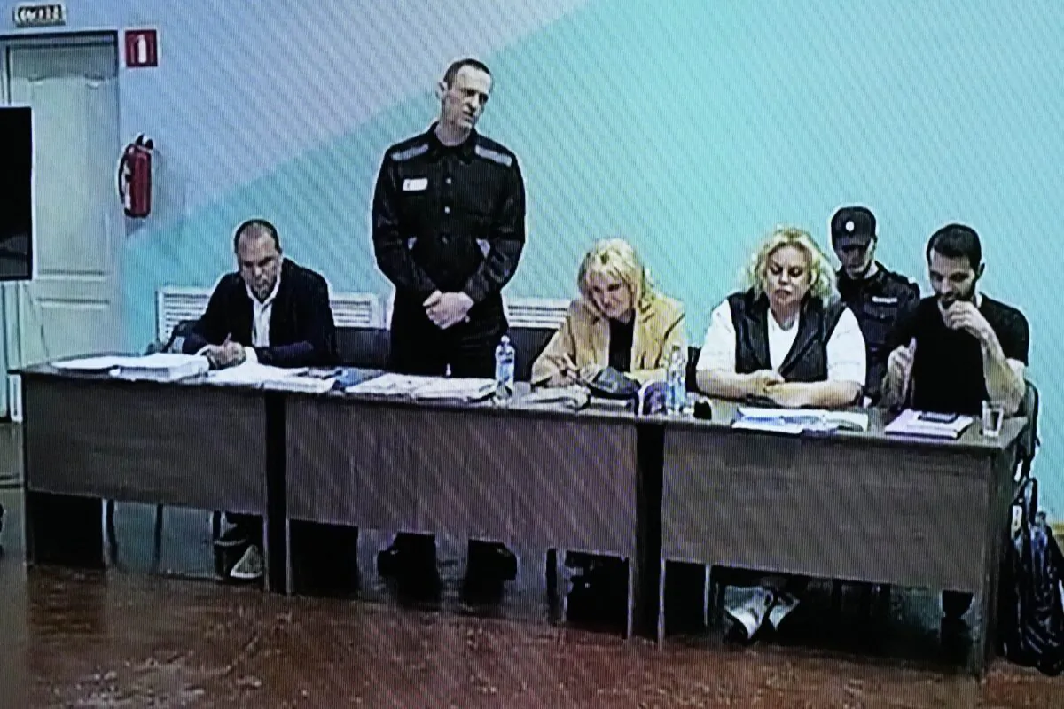A TV Screen showing Russian opposition leader Alexei Navalny (2nd left), between his lawyers in a courtroom, via video link provided by the Russian Federal Penitentiary Service, during a preliminary hearing, in Melekhovo, Vladimir region, about 260 kilometers (163 miles) northeast of Moscow, Russia, on June 19, 2023. (Alexander Zemlianichenko/AP Photo)