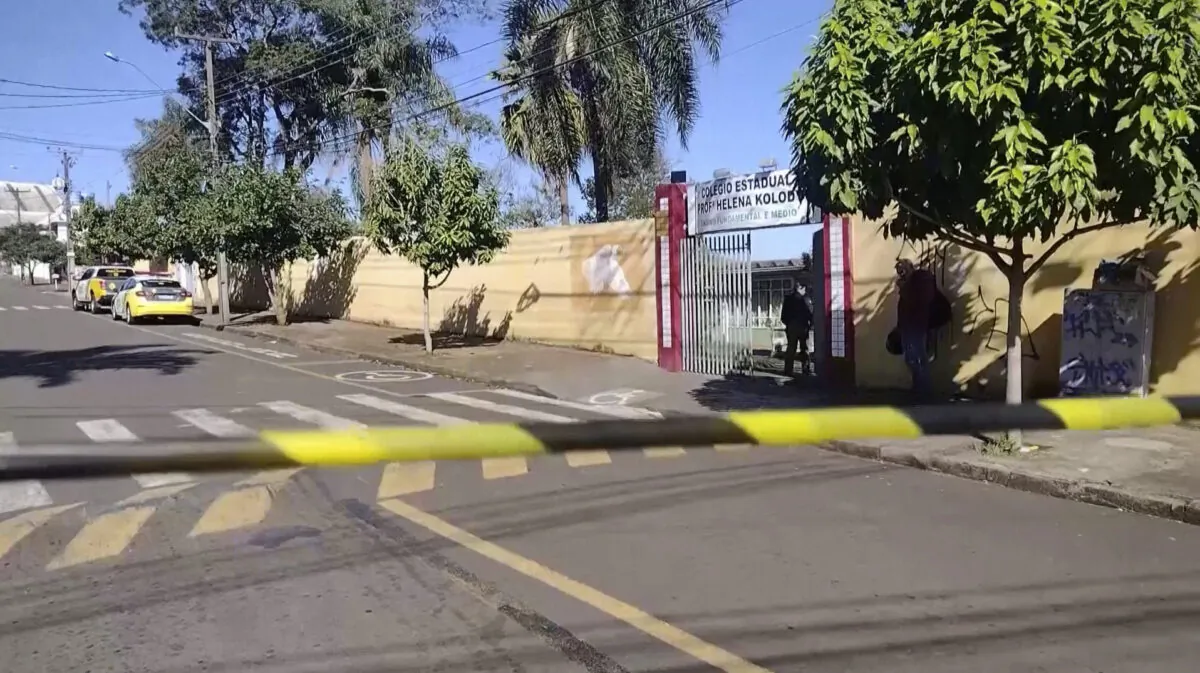 Police tape blocks off a street near Professora Helena Kolody public school in Cambe, Parana, Brazil, on June 19, 2023, in a still from video. (Reuters/Screenshot via The Epoch Times)