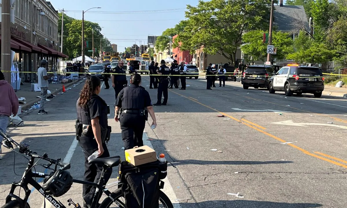 Milwaukee police investigate a shooting along North King Drive near Locust Street, in Milwaukee, Wis., on June 19, 2023. (Bill Glauber/Milwaukee Journal-Sentinel via AP)