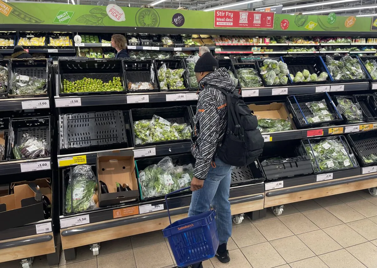 A customer shops for vegetables in the fruit and vegetable section of a Sainsbury's supermarket in east London on Feb. 20, 2023. (Daniel Leal/AFP via Getty Images)