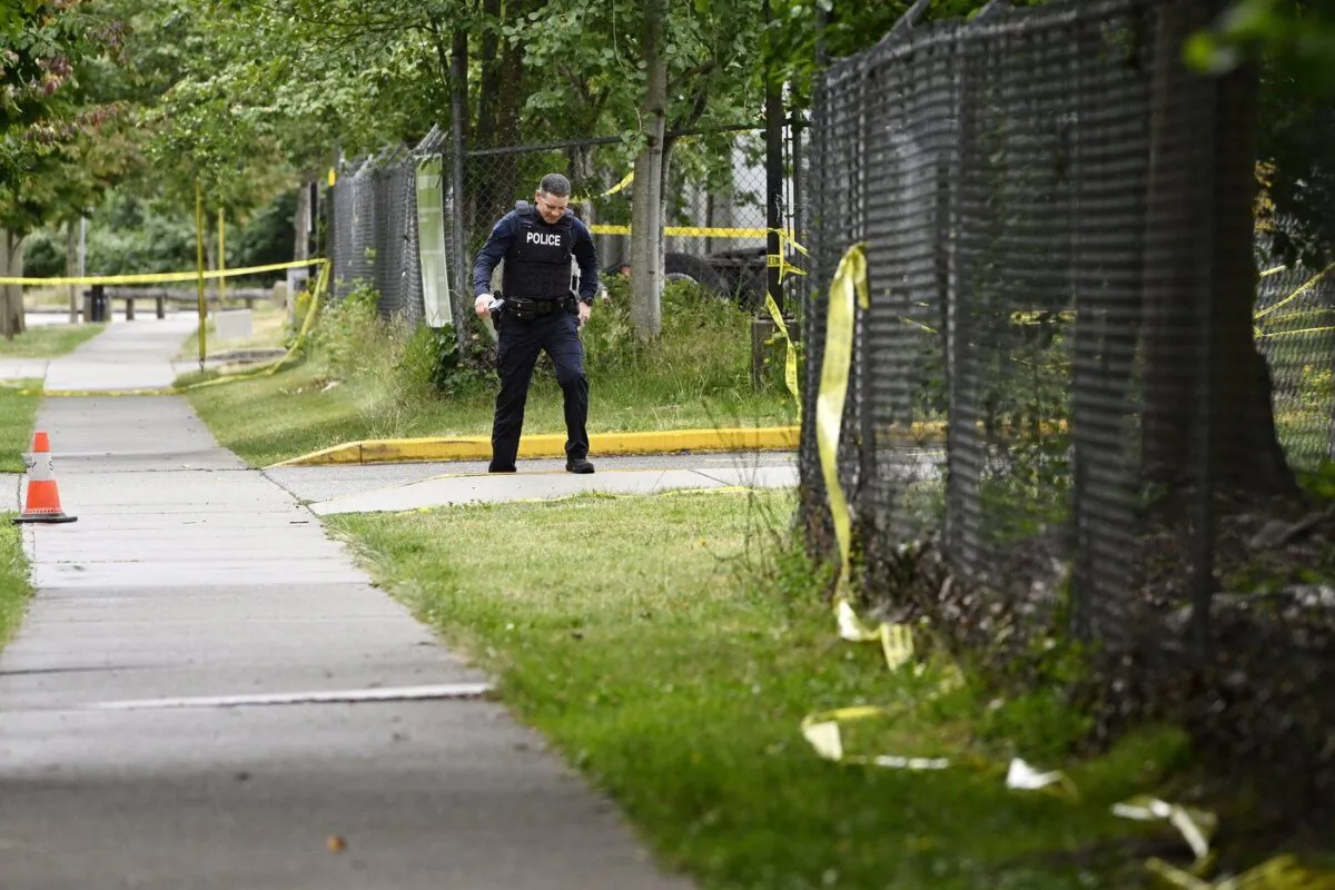 A police officer surveys the scene near the Guru Nanak Sikh Gurdwara Sahib temple after a shooting in Surrey, B.C., June 19, 2023. (The Canadian Press/Jennifer Gauthier)