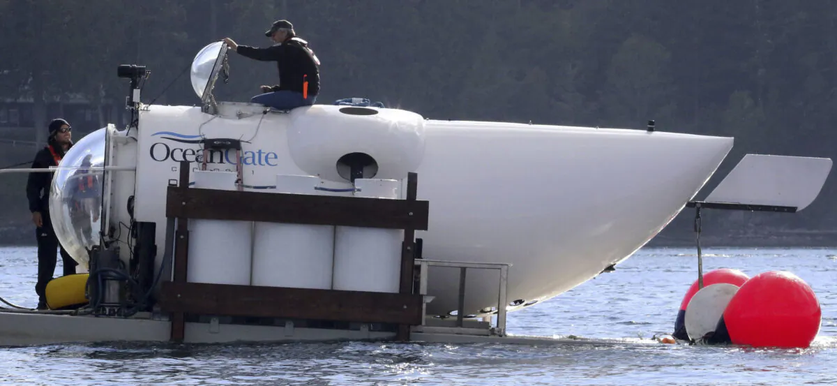 OceanGate CEO Stockton Rush emerges from the hatch atop the OceanGate submarine Cyclops 1 in the San Juan Islands, Wash., on Sept. 12, 2018. (Alan Berner/The Seattle Times via AP)