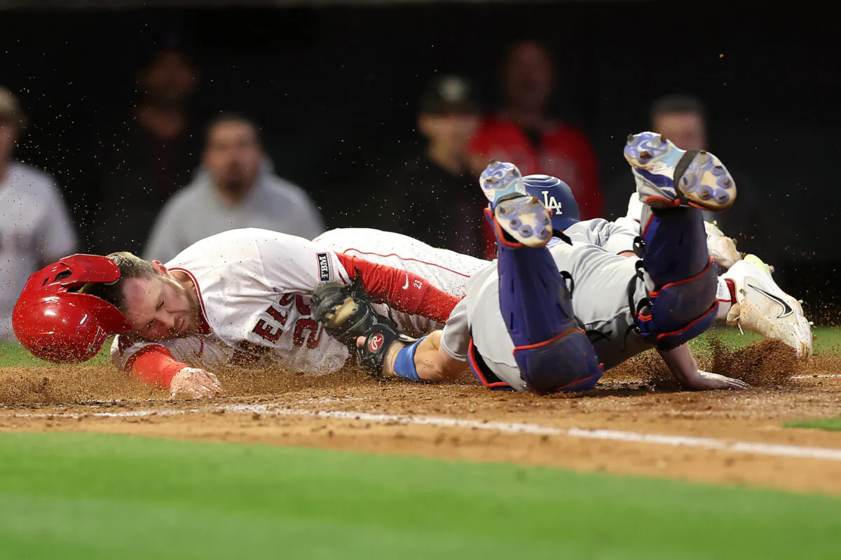 Brandon Drury (23) of the Los Angeles Angels is tagged out at home-plate by Will Smith (16) of the Los Angeles Dodgers during the fourth inning of a game at Angel Stadium of Anaheim in Anaheim, Calif., on June 20, 2023. (Sean M. Haffey/Getty Images)